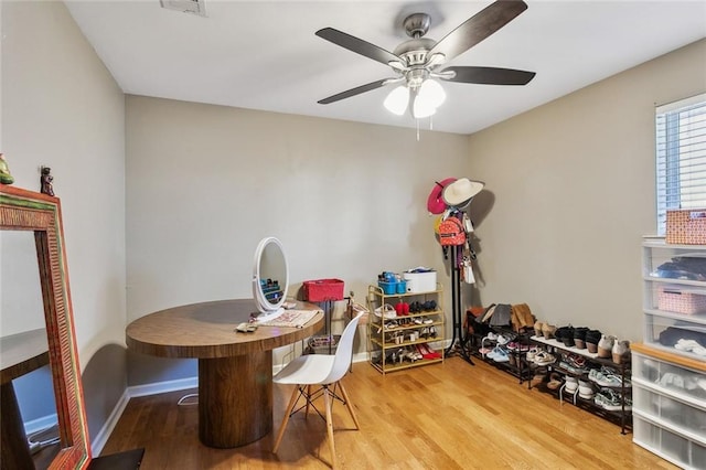 dining area featuring wood-type flooring and ceiling fan