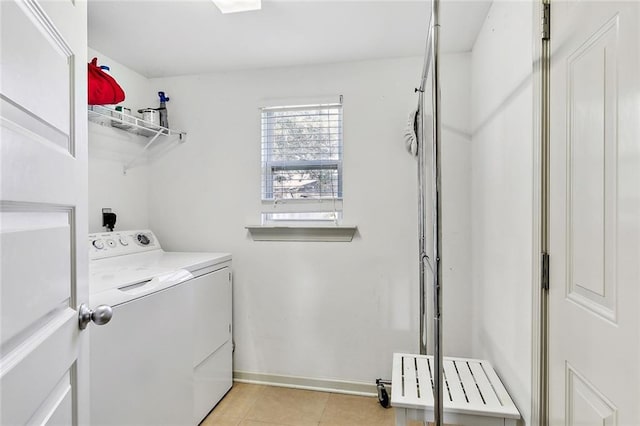 laundry room featuring washing machine and dryer and light tile patterned floors