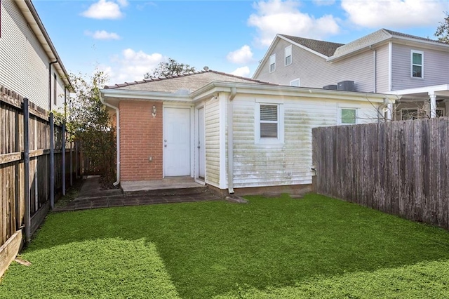 rear view of property featuring a yard