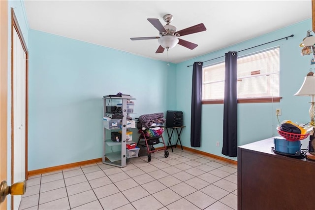 office area featuring light tile patterned floors, baseboards, and a ceiling fan