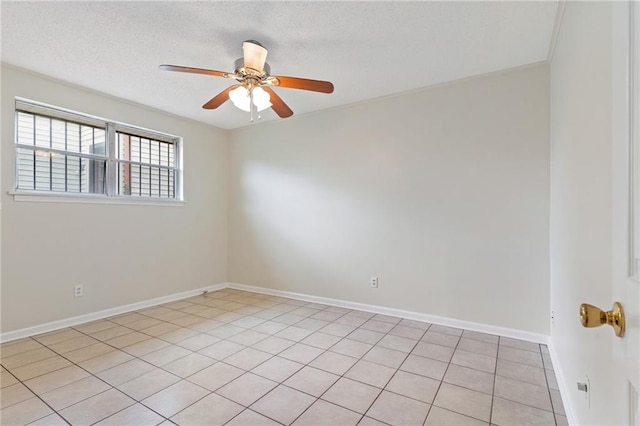 spare room with a textured ceiling, baseboards, and a ceiling fan