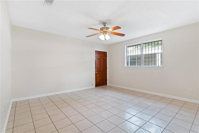 unfurnished room featuring visible vents, ceiling fan, and baseboards