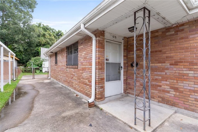 exterior space with brick siding and fence