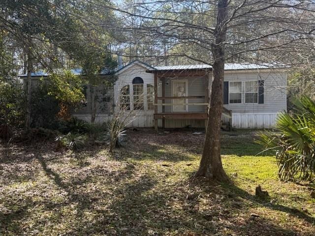 rear view of property with a lawn