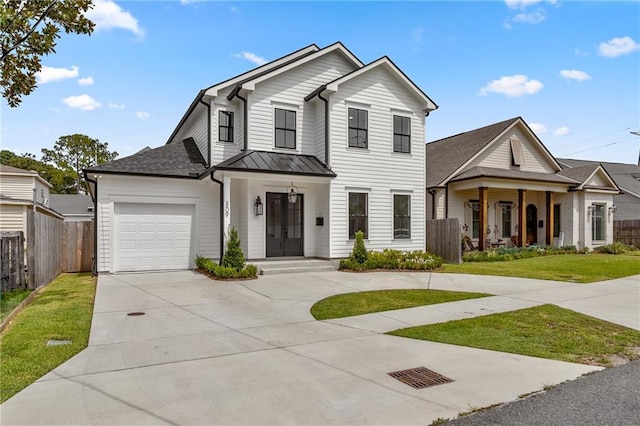 view of front of property featuring a porch, a garage, and a front lawn