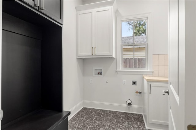 clothes washing area with hookup for an electric dryer, hookup for a gas dryer, cabinets, and washer hookup