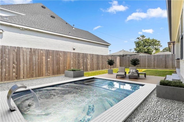 view of swimming pool with a hot tub