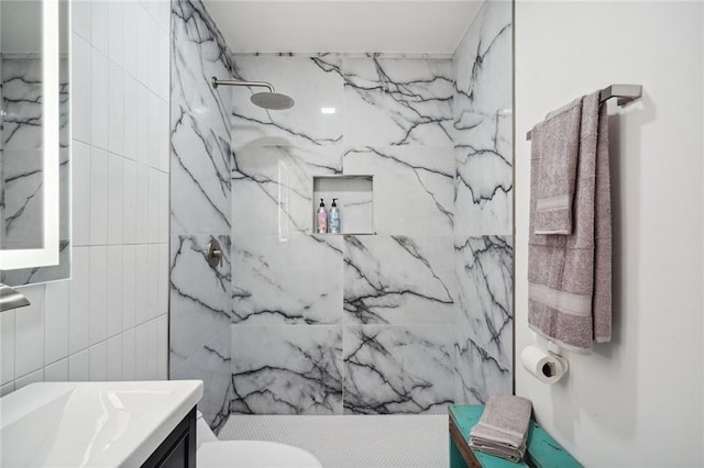 bathroom featuring a shower, vanity, and toilet