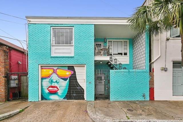 2604 Chartres St, New Orleans, LA 70130 - view of front facade with brick siding and a gate