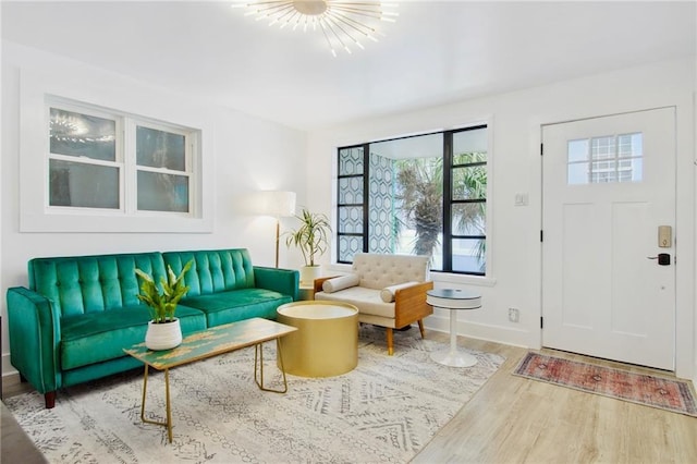 living room with hardwood / wood-style flooring and a chandelier