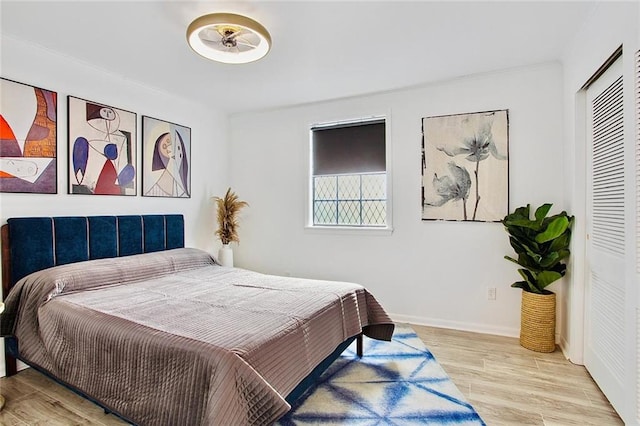2604 Chartres St, New Orleans, LA 70130 - bedroom featuring wood finished floors, a closet, and baseboards