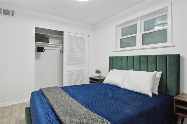 bedroom featuring wood-type flooring and a closet