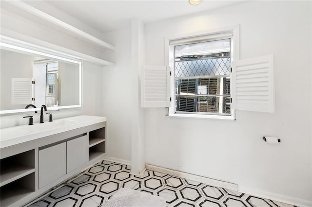 2604 Chartres St, New Orleans, LA 70130 - bathroom featuring tile patterned floors, baseboards, and vanity