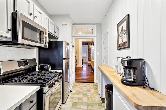 1512 Saint Ann St, New Orleans, LA 70116 - kitchen featuring stainless steel appliances, wooden counters, and tasteful backsplash