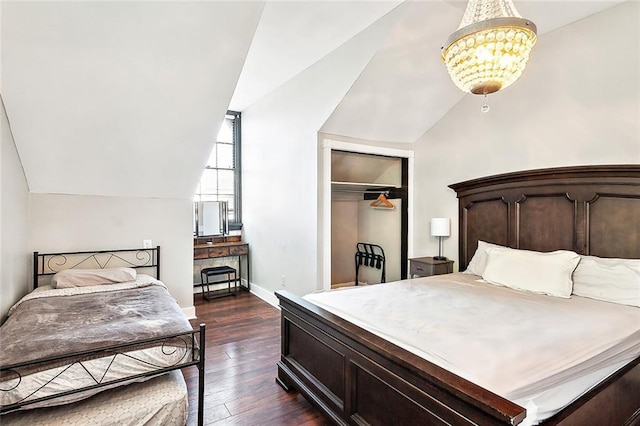 1512 Saint Ann St, New Orleans, LA 70116 - bedroom featuring a closet, an inviting chandelier, baseboards, dark wood-type flooring, and vaulted ceiling