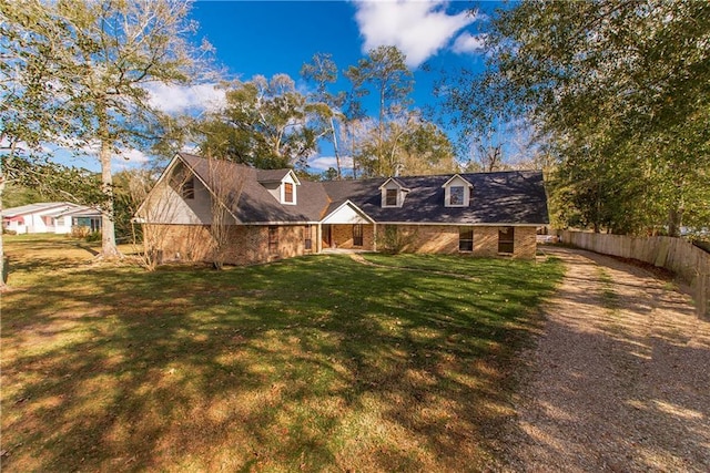 new england style home featuring a front yard