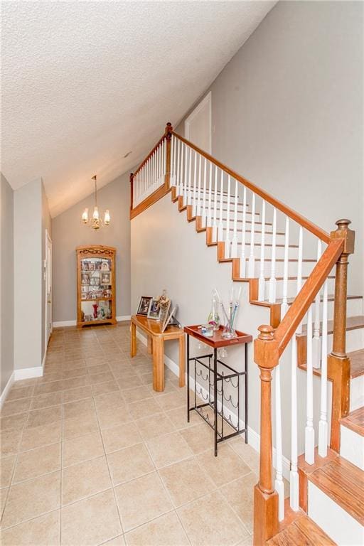 staircase featuring a textured ceiling, tile patterned flooring, vaulted ceiling, and a notable chandelier