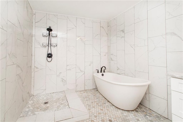 bathroom with a tub to relax in and tile patterned floors