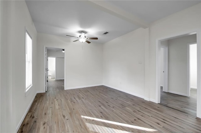 empty room with ceiling fan and light hardwood / wood-style flooring