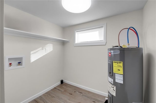 laundry room featuring water heater, hookup for a washing machine, and light hardwood / wood-style floors