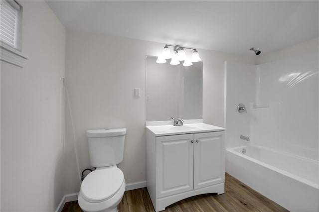 full bathroom with hardwood / wood-style floors, vanity, shower / bath combination, and toilet