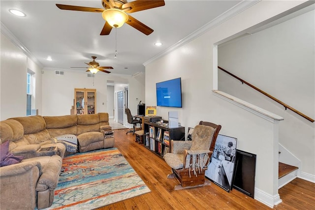 living room featuring ceiling fan, crown molding, and hardwood / wood-style flooring