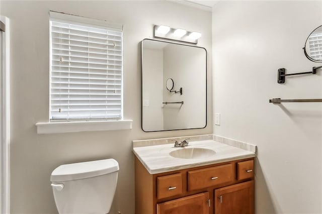 bathroom featuring vanity, toilet, and ornamental molding