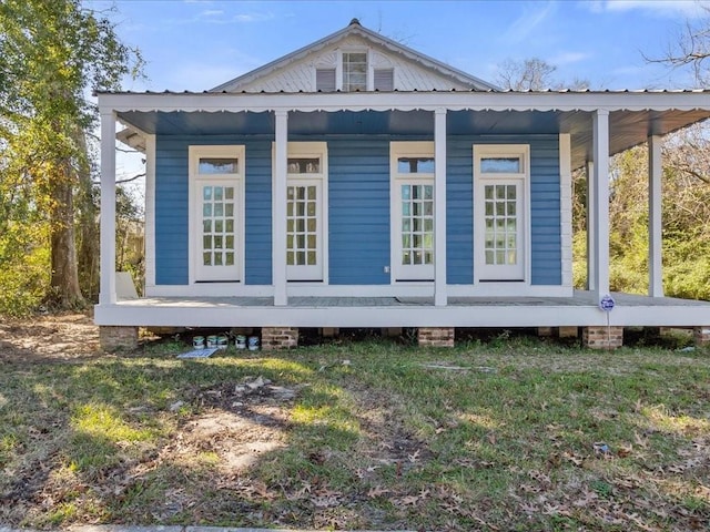 view of side of property featuring covered porch