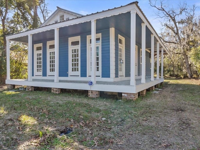 view of side of home with a porch