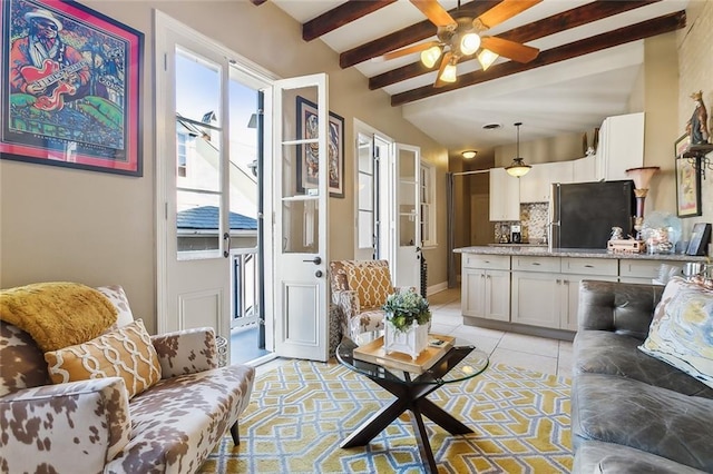 living room with beamed ceiling, light tile patterned floors, a wealth of natural light, and ceiling fan