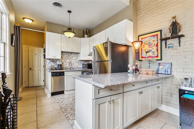 kitchen featuring kitchen peninsula, white cabinets, and stainless steel appliances