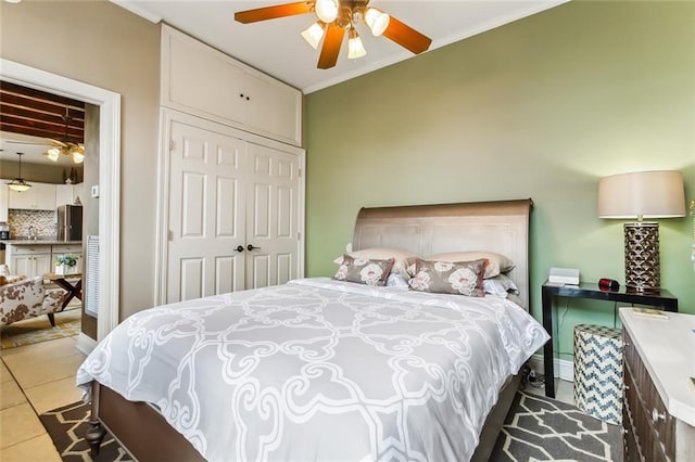 tiled bedroom featuring a closet, stainless steel refrigerator, ceiling fan, and crown molding