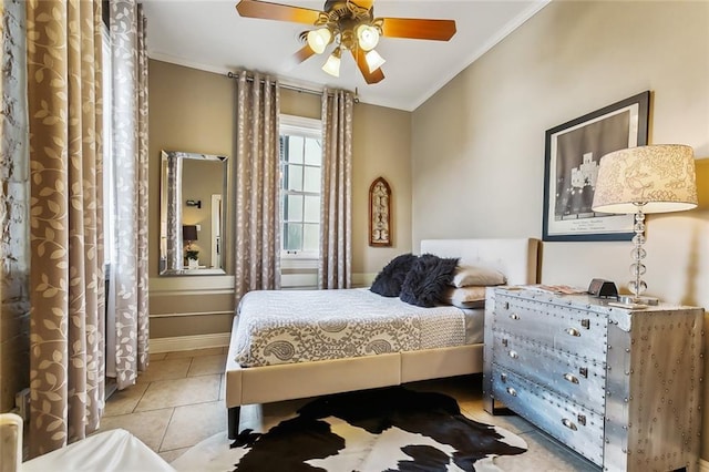 tiled bedroom with ceiling fan and crown molding