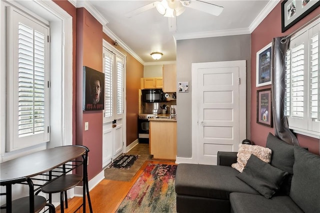 living room with light wood-type flooring, ceiling fan, and ornamental molding