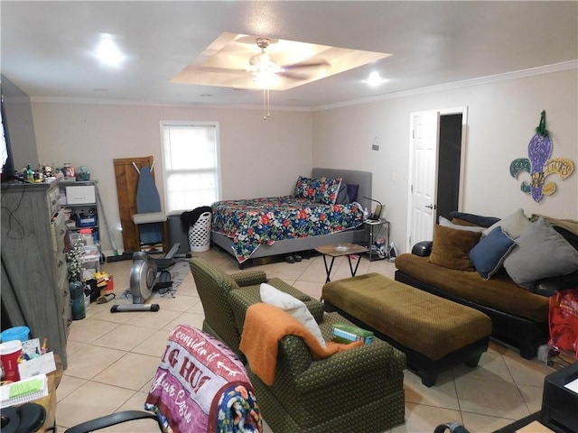 tiled bedroom with ceiling fan, ornamental molding, and a tray ceiling