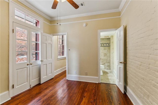 unfurnished bedroom featuring ceiling fan, dark hardwood / wood-style flooring, ornamental molding, and french doors