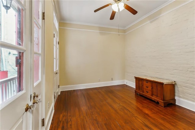 empty room featuring ceiling fan, wood-type flooring, and crown molding