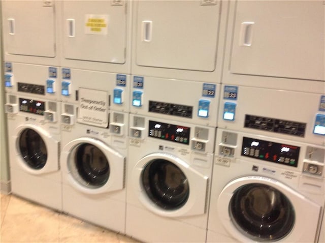 1205 St Charles Ave Unit 916, New Orleans, LA 70130 - community laundry room featuring stacked washer and clothes dryer, washer and clothes dryer, and light tile patterned floors