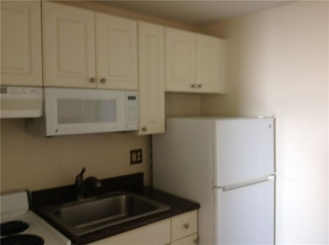 1205 St Charles Ave Unit 916, New Orleans, LA 70130 - kitchen featuring white appliances, extractor fan, dark countertops, and white cabinets