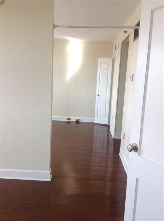 1205 St Charles Ave Unit 916, New Orleans, LA 70130 - hallway featuring dark wood-style floors and baseboards