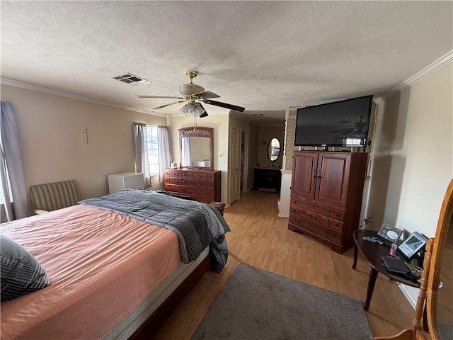 10923 Chaucer St, New Orleans, LA 70127 - bedroom featuring ornamental molding, light wood finished floors, a textured ceiling, and ceiling fan