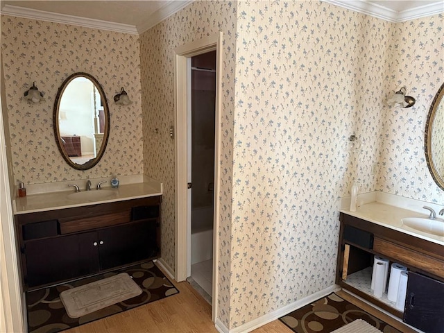 bathroom with hardwood / wood-style floors, vanity, and ornamental molding