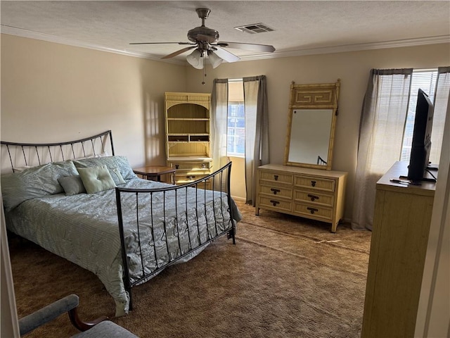 carpeted bedroom featuring multiple windows, a textured ceiling, ceiling fan, and ornamental molding