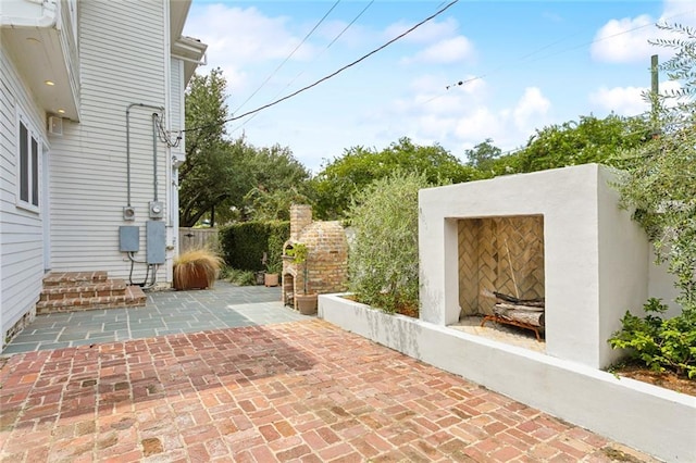 view of patio / terrace featuring an outdoor fireplace