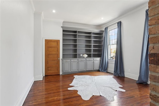 interior space with ornamental molding and dark hardwood / wood-style floors