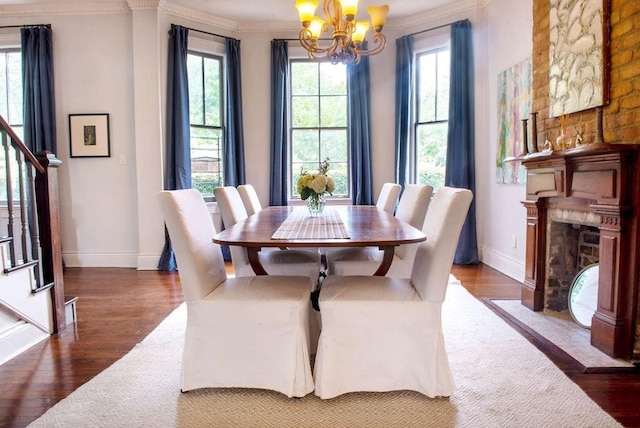 dining space featuring an inviting chandelier, a high end fireplace, and dark hardwood / wood-style flooring