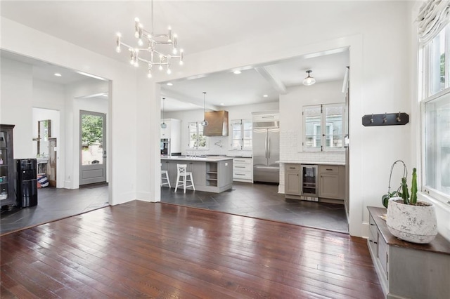 living room with wine cooler, a wealth of natural light, and dark wood-type flooring