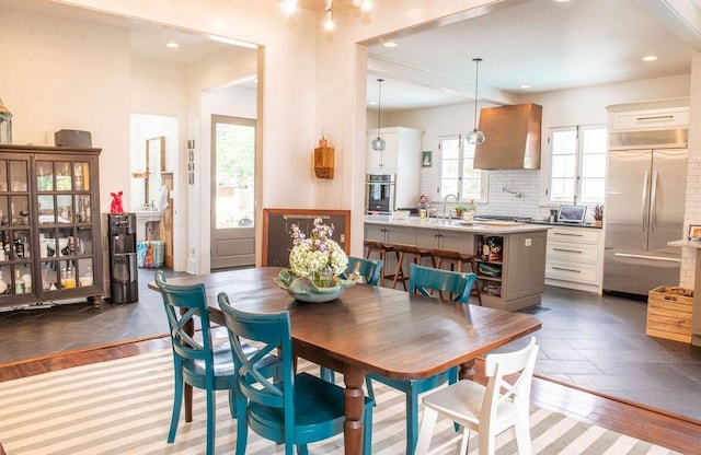 dining space with sink and dark wood-type flooring