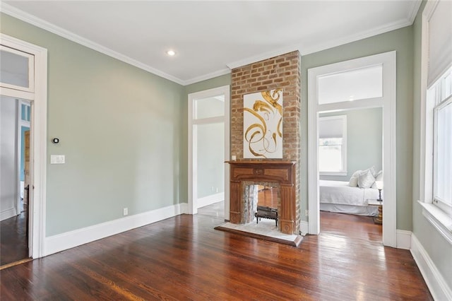 unfurnished living room featuring a fireplace, ornamental molding, and dark hardwood / wood-style floors