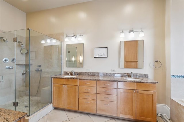 bathroom with tile patterned flooring, vanity, and an enclosed shower